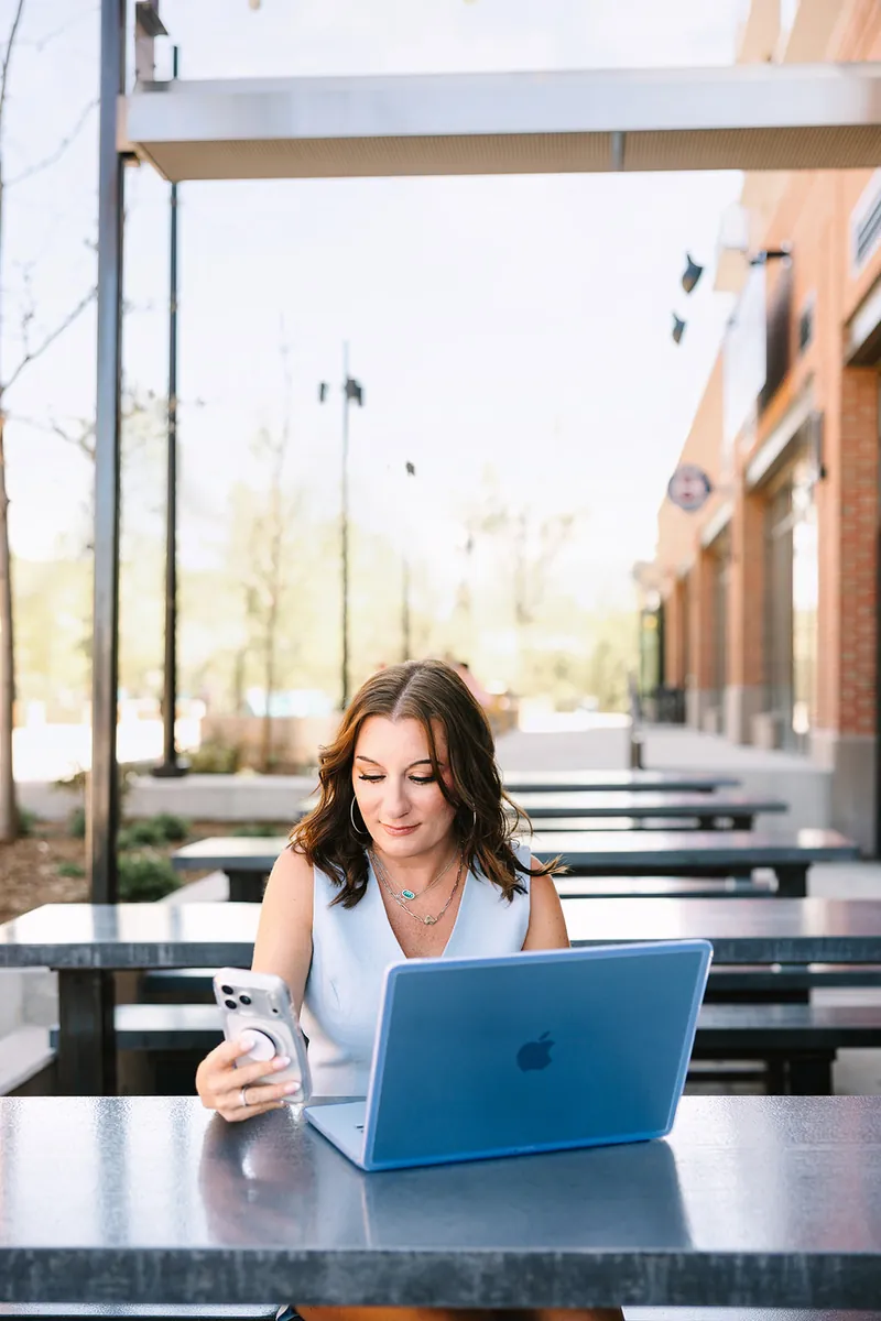 Jessica Lentz working on a laptop at an outdoor table in Castle Rock