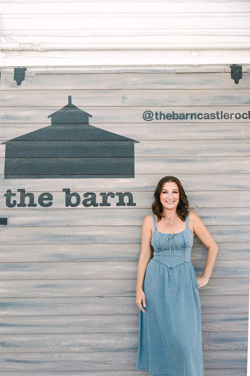 Jessica Lentz in front of The Barn Castle Rock mural