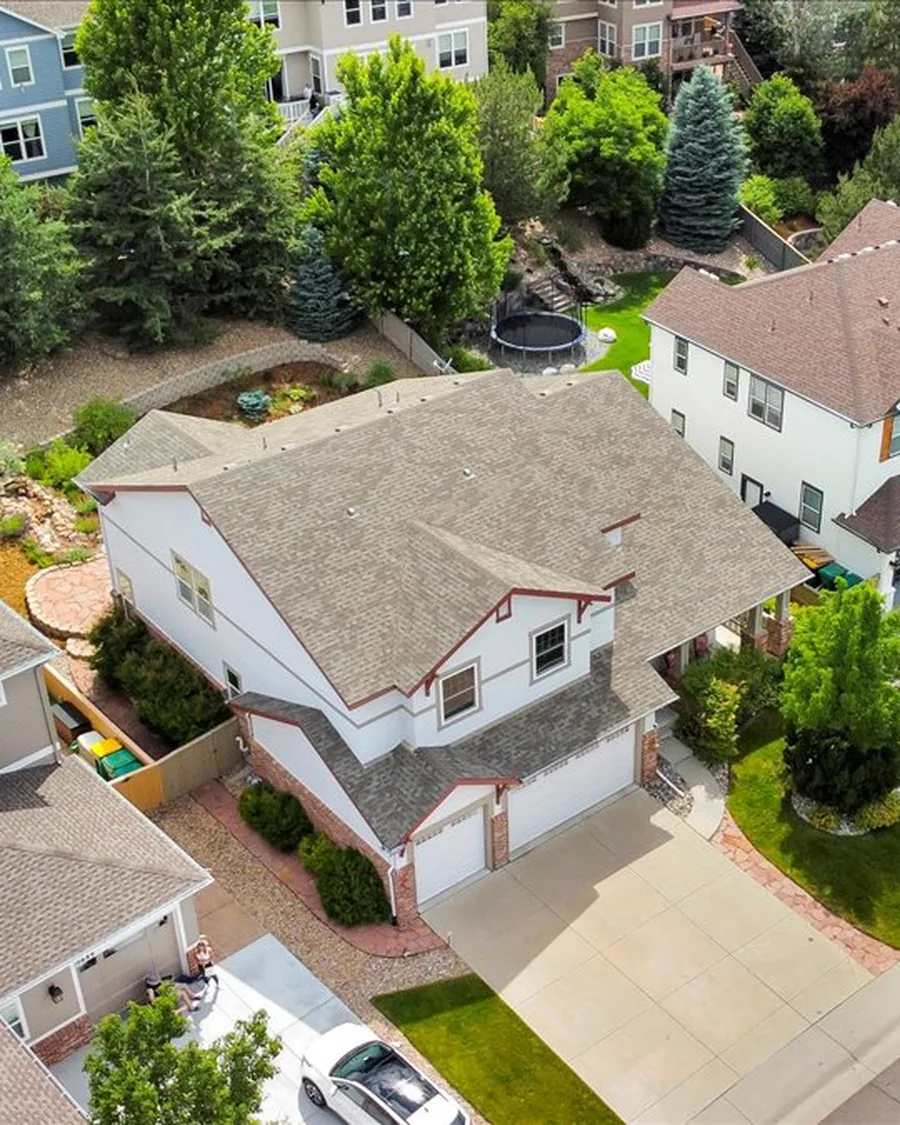 Aerial view of a two-story Highlands Ranch home with a three-car garage and a landscaped, terraced backyard, one of Jessica's listings